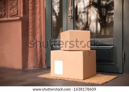 Delivered parcels on door mat near entrance