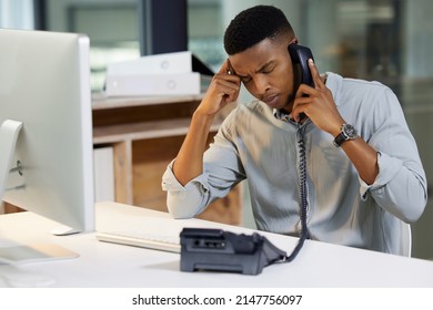 Delivering Bad News Is A Tough Call To Make. Shot Of A Young Man Using A Phone And Looking Stressed In A Modern Office.