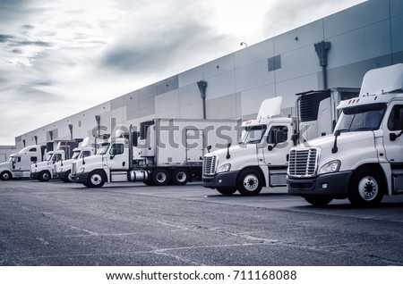 Delivering or Supply concept image.  Trucks loading at facility.