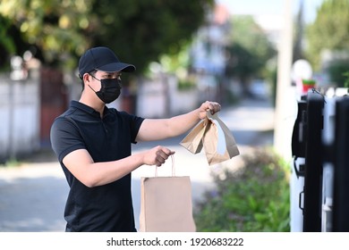 Delivery Asian Man Wear Protective Mask And Delivering Food At Doorway.