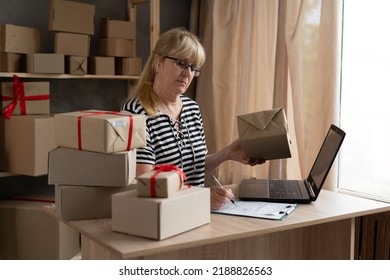 Delivery Business. Happy Older Female With Laptop And Parcels Using Applications In The Warehouse. Online Marketing, Packing Boxes, SME Sellers, Concept, E-commerce Team