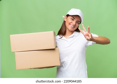 Delivery Caucasian Woman Holding Boxes Isolated On Green Chroma Background Happy And Counting Three With Fingers