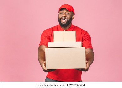 Delivery Concept. African American Delivery Black Man Carrying Parcel Isolated Over Pink Background. 