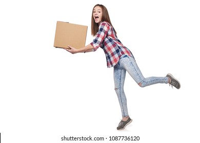 Delivery concept. Full length excited woman running hurrying carrying cardboard box, isolated on white background