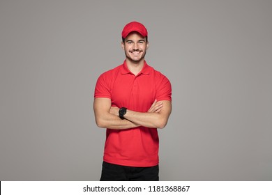 Delivery Concept - Smiling Caucasian courier man posing on studio background.