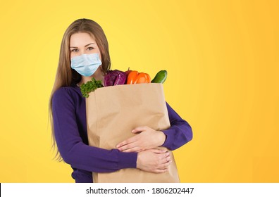 Delivery Concept With A Delivery Woman With A Mask Carrying Bag With A Grocery