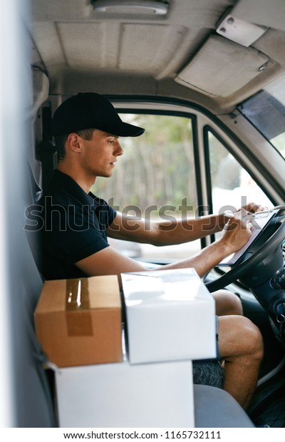 Delivery Courier In Car With Boxes. Man\
Delivering Packaging