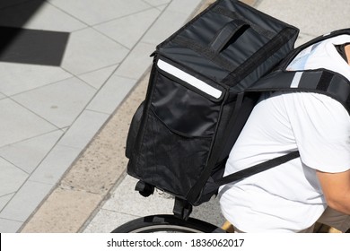 Delivery Courier Carrying A Black Backpack