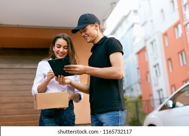 Delivery Courier. Man Delivering Package To Woman