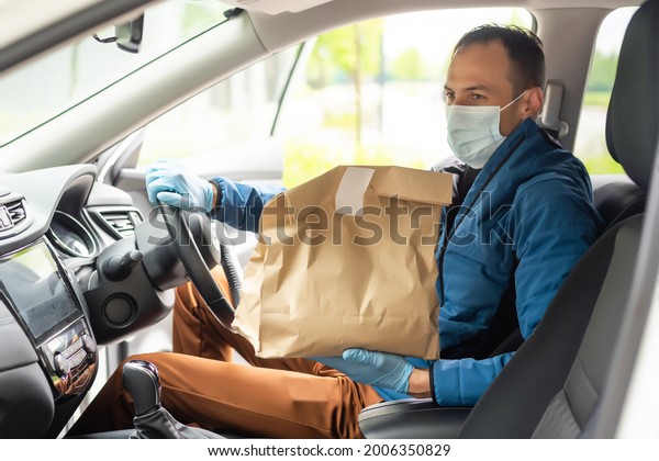 Delivery driver\
driving with parcels on\
seat