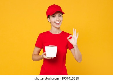 Delivery Employee Woman In Red Cap Blank T-shirt Work Courier In Service During Quarantine Coronavirus Covid-19 Virus Holding Chinese Food Takeaway Carton Container Box Isolated On Yellow Background