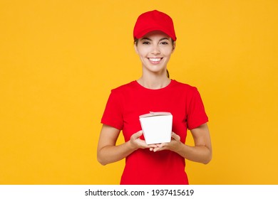 Delivery Employee Woman In Red Cap Blank T-shirt Work Courier In Service During Quarantine Coronavirus Covid-19 Virus Holding Chinese Food Takeaway Carton Container Box Isolated On Yellow Background