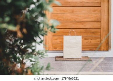 Delivery food in paper bag for customer during corona virus spreading at front door home - Powered by Shutterstock