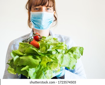 Delivery Girl Or Small Shop Owner Wearing Protective Face Mask Holding Fresh Produce In Gloved Hands. Safe Delivery, Local Grocery Shopping During Coronavirus Pandemic