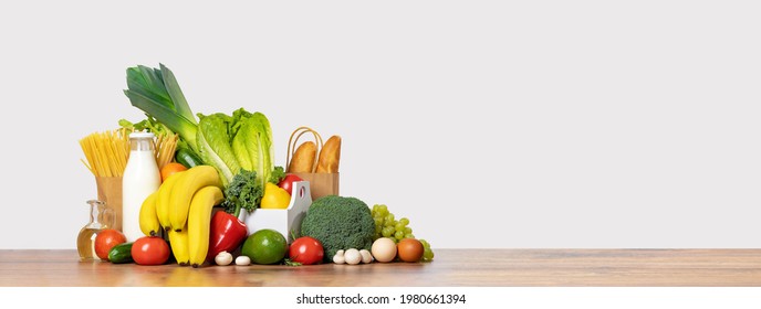 Delivery of grocery. Group of fresh fruit and vegetables bright green produce bread. Eco friendly responsible lifestyle and shopping. Healthy eating, zero waste concept. Copy space. Donation. Banner - Shutterstock ID 1980661394