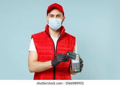Delivery Guy Employee Man In Red Cap T-shirt Vest Uniform Sterile Face Mask Gloves Work Courier Service On Lockdown Covid-19 Flu Virus Hold Credit Bank Card Terminal Isolated On Pastel Blue Background