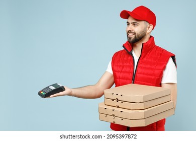 Delivery guy employee man in red cap white T-shirt vest uniform workwear work as dealer courier hold terminal pizza in cardboard flatbox isolated on pastel blue color background studio Service concept - Shutterstock ID 2095397872