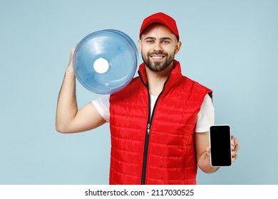 Delivery Guy Employee Man In Red Cap White T-shirt Vest Uniform Workwear Work As Dealer Courier Hold Water Bottle Use Mobile Cell Phone Isolated On Pastel Blue Color Background Studio. Service Concept