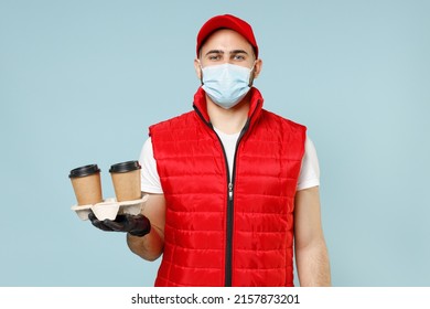 Delivery Guy Employee Man In Red Cap White T-shirt Vest Uniform Sterile Face Mask Gloves Work Courier Service On Lockdown Covid-19 Flu Virus Hold Paper Cup Of Coffee Isolated On Pastel Blue Background