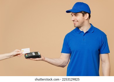 Delivery guy fun employee man wear blue cap t-shirt uniform workwear work as dealer courier hold wireless modern bank payment terminal process acquire credit card isolated on plain beige background - Shutterstock ID 2253129825