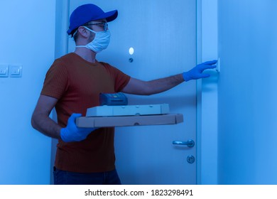 Delivery Guy With Protective Mask Holding Pizza Box At The Door.