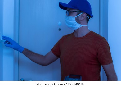 Delivery Guy With Protective Mask Holding Pizza Box At The Door.