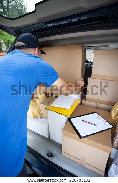 Delivery guy\
sorting through packages in his\
van