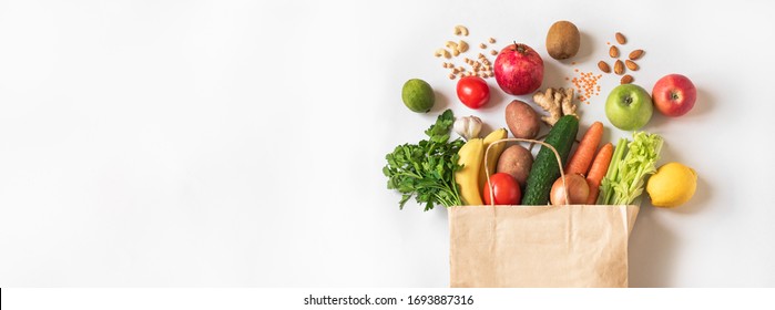 Delivery Healthy Food Background. Vegan Vegetarian Food In Paper Bag Vegetables And Fruits, Nuts And Grains On White, Copy Space, Banner.Grocery Shopping Food Supermarket And Clean Eating Concept.