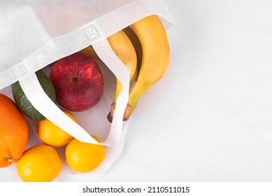 Delivery Healthy Food Background. Vegan Vegetarian Food In Fabric Bag Fruits On White, Copy Space, Banner. Grocery Shopping Food Supermarket And Clean Eating. Zero Waste Concept. No Plastic