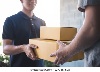 Delivery Mail Man Giving Parcel Box To Recipient, Young Owner Accepting Of Cardboard Boxes Package From Post Shipment, Home Courier And Delivery Service Mind Concept.