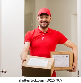 Delivery, Mail, People And Shipment Concept - Happy Man In Red Uniform With Parcel Boxes At Open Customer Door