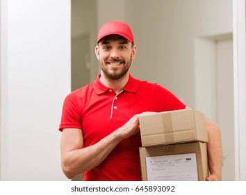 Delivery, Mail, People And Shipment Concept - Happy Man In Red Uniform With Parcel Boxes In Corridor