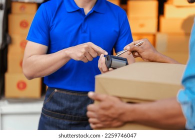 Delivery man asia people checking portable delivery device with parcel box to customer home address. give delivery box to customer and sign a signature of receiver people - Powered by Shutterstock