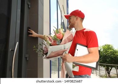 Delivery Man With Beautiful Flower Bouquet Near Front Door