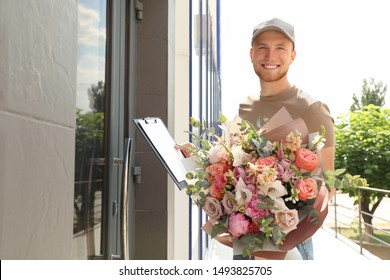 Delivery Man With Beautiful Flower Bouquet Near Front Door