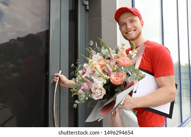 Delivery Man With Beautiful Flower Bouquet Near Front Door