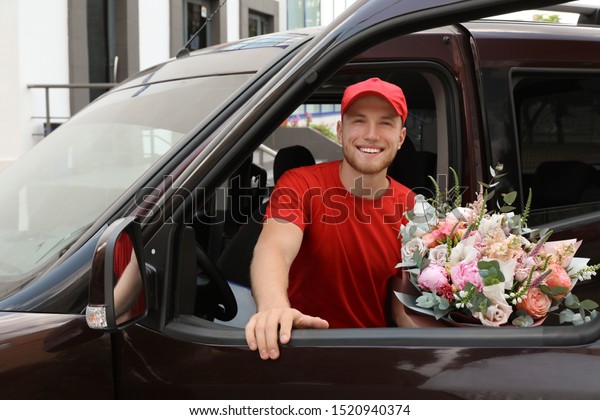 Delivery\
man with beautiful flower bouquet leaving\
car