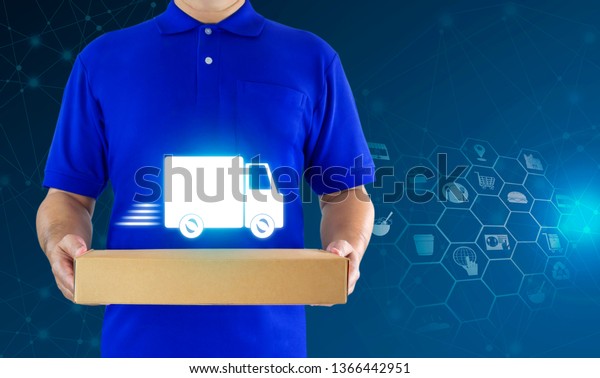 Delivery man in blue uniform and hands holding\
paper box for delivering package on icon media background. Concept\
fast food delivery service or order online shopping. with copy\
space for text.