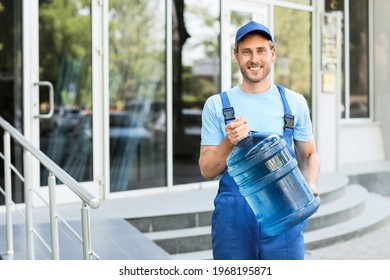 Delivery man with bottle of water outdoors