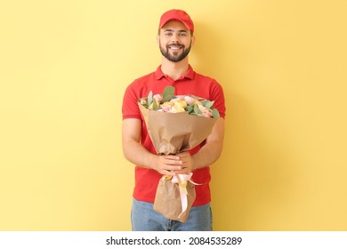 Delivery Man With Bouquet Of Flowers On Color Background