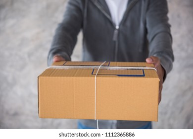delivery man with box - Shutterstock ID 1112365886