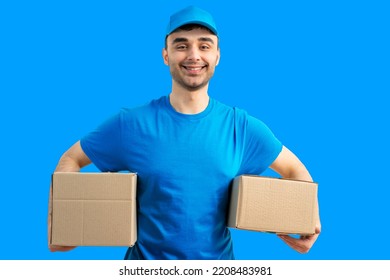 Delivery man with a box. Courier in uniform cap and t-shirt service fast delivering orders. Young guy holding a cardboard package. Character on isolated white background for mockup design. - Shutterstock ID 2208483981