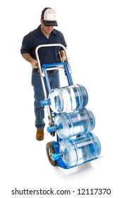 Delivery Man Bringing Five Gallon Water Bottles On A Hand Truck.  Room For Your Logo On His Hat.  Full Body Isolated On White.