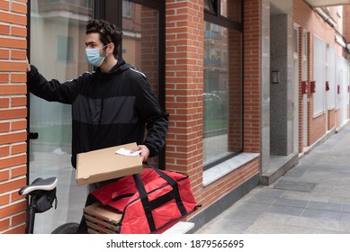 Delivery Man Calling The Doorman, Wearing A Face Mask, Holding A Red Bag For Home Delivery