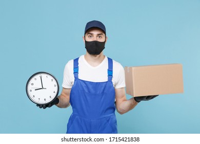 Delivery man in cap tshirt uniform sterile face mask gloves isolated on blue background studio. Guy employee courier hold cardboard box Service quarantine coronavirus virus covid-19 2019-ncov concept