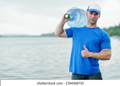 Delivery Man Carrying Water Bottle On Shoulder.