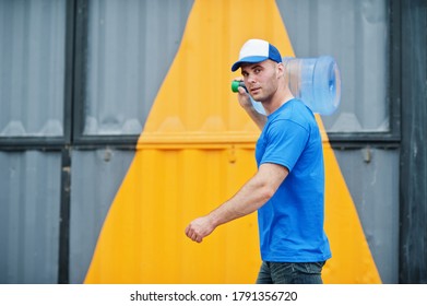 Delivery Man Carrying Water Bottle On Shoulder.