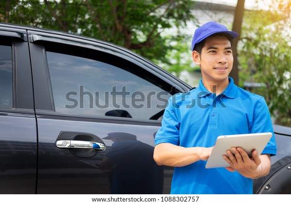 Delivery man checking\
document list on clipboard outdoor and Cardboard Boxes, Package\
delivery concept