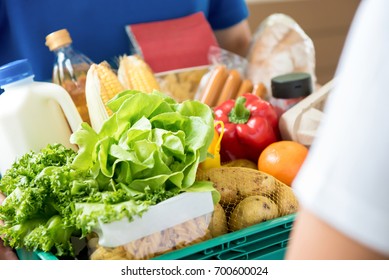 Delivery Man Delivering Food To Customer At Home - Online Grocery Shopping Service Concept