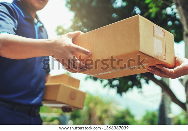 Delivery
man delivering holding parcel box to
customer